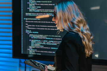 Female Software Engineer Presenting Code During Technical Meeting