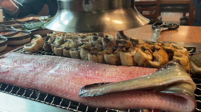 Grilled eel on charcoal fire &ndash; Korean BBQ cooking with smoke and sizzling seafood 4K
