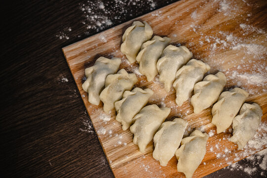 Delicious homemade dumplings arranged on a wooden cutting board