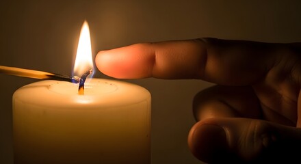 A hand lighting a white candle with a matchstick in a dimly lit room creating a warm ambiance glow