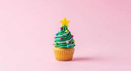 A single cupcake decorated as a Christmas tree with green frosting, colorful sprinkles, and a yellow star on a pink background.