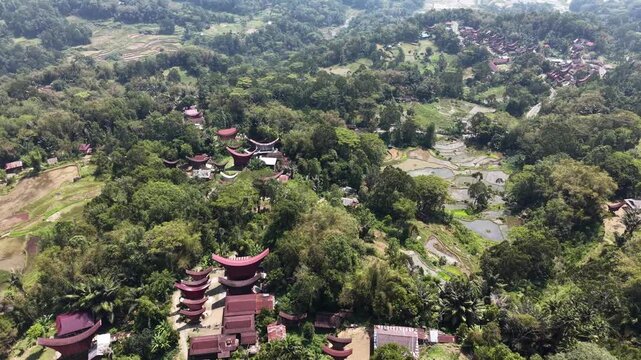Aerial view of lush rice paddies surrounded by tropical vegetation and forest near Rantepao, Tana Toraja, Indonesia.	