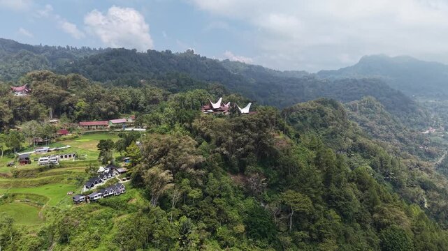 Aerial view of lush green mountain peaks covered with dense tropical forest in Tana Toraja, Indonesia.
