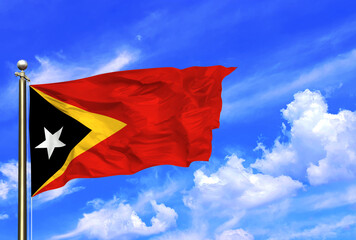 East Timor Flag Waving In The Wind On A Beautiful Summer Blue Sky