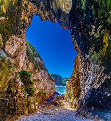A view inside a sea cave on West Head headland across the strait of the knysna river, South Africa in Springtime