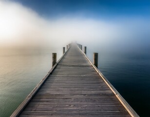 Fototapeta premium ethereal perspective of a wooden pier disappearing into a horizon concealed by fog