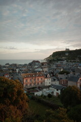 Fototapeta premium Scenic View of French Coastal Town and Hilltop Chapel at Sunset in Normandy, France