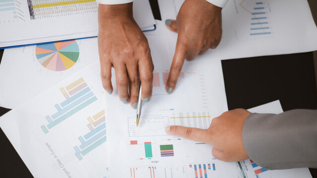 Business Team Analyzing Financial Charts and Data Reports in Meeting
