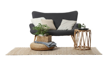 Stylish sofa with cushions, coffee table, pouf, plant and rug isolated on white