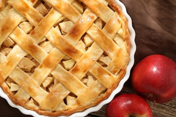 Tasty homemade apple pie and fresh fruits on wooden table, flat lay
