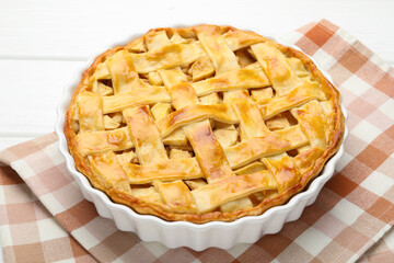 Delicious homemade apple pie on white wooden table, closeup