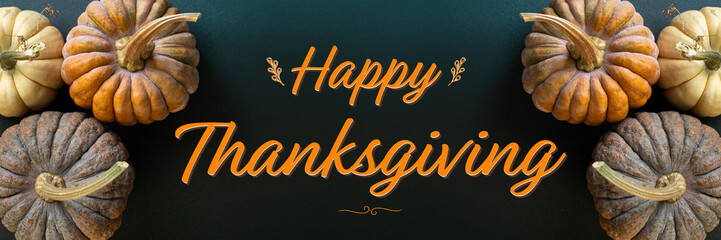Thanksgiving greetings card. Thanksgiving day background pumpkins, autumn decorations on dark background. Happy Thanksgiving concept