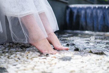 Woman Relaxing, Dipping Feet in Clear Water Stream