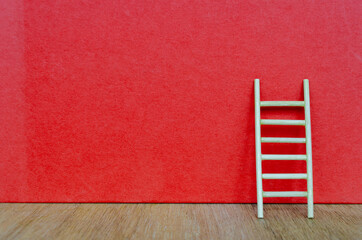 Small ladder on red cover background with customizable space for text.