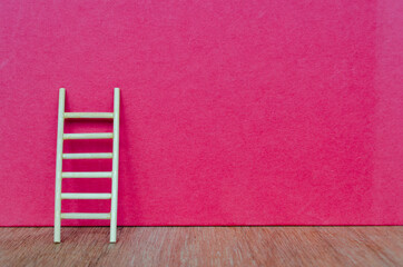 Ladder representing hard work on dark red cover background with customizable space for text.