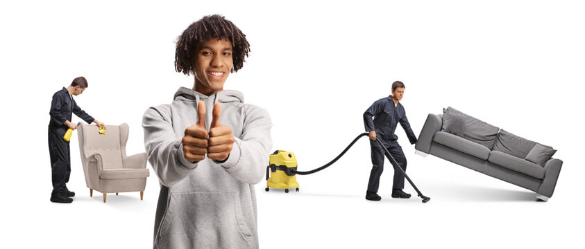 Cleaners cleaning an apartment and cheerful young african american man gesturing thumbs up