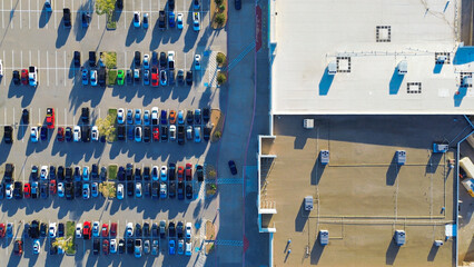 Dense outdoor parking at large Lewisville retail strip with gas and electric vehicles, ADA spaces...