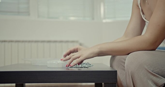 Experience the calming and satisfying ASMR sounds of a woman's hands sorting small metal objects. The gentle, rhythmic clicks and movements create a relaxing auditory and visual experience.