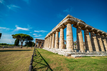 view of greek ancient ruins forum in Peastum, salerno with a blue sky in background