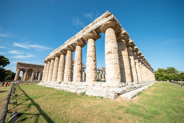 view of greek ancient ruins forum in Peastum, salerno with a blue sky in background