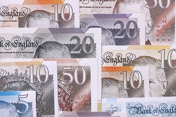 British pounds currency money bills in big amount. Many GBP currency banknotes with different...