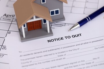 Generic house and eviction notice or notice to quit on table close up
