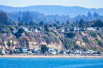 Scenic view of Potbelly Beach California USA with coastal houses on seaside cliffs above blue Pacific Ocean showing peaceful coastal living and natural beauty of the Central California coastline