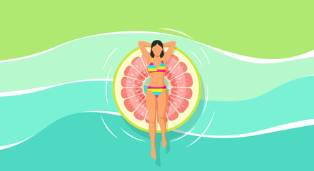 Summer Relaxation: A Woman Floats on Water With Grapefruit Pool Inflatable