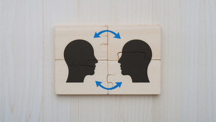 Jigsaw puzzle depicting head silhouettes symbolizing communication and understanding process