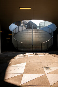 Minimal architecture surrounding a clean open public plaza with empty space and geometric structure, representing modern urban design in a modern European city under soft daylight tones.