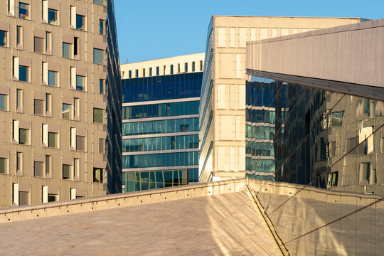 Wide view of urban architecture showing a clean public space with minimal concrete structure and modern plaza design, completely empty in a modern European city under soft daylight.