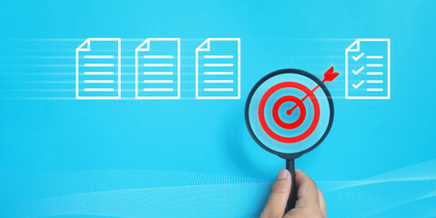  Business concept, data analysis with magnifying glass focused on red target icon among document icons on blue background, representing accuracy, goal achievement and strategic decision making process