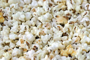 Flatlay of salted popcorn with cheese. Heap of homemade delicious popcorn on a rustic wooden table