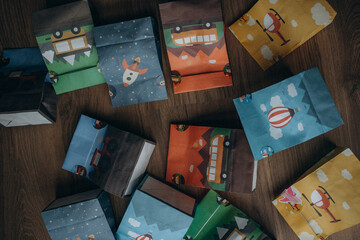 Small gift bags for guests at a child's birthday party. Multi-colored gift bags with transport: a...