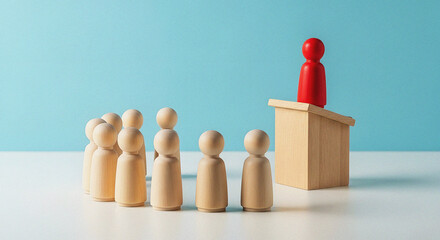 Corporate Public Speaking and Effective Leadership Training Seminar Concept Red Wooden Figure Presenting from a Podium to a Small Group of Listeners