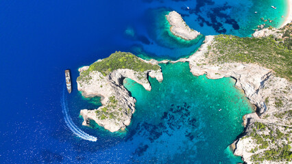 Aerial drone photo of not so famous paradise bay and caves of Saint Andrews islet creating a blue...
