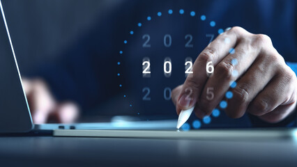 2026 business planning: Annual review, goals, and strategy. Businessman on laptop working on 2025-2026 transition, forecasting future success, innovation, and digital transformation.