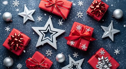 Assortment of festive red gift boxes and silver decorations scattered across a dark blue snowy surface