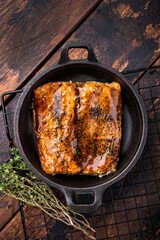 Teriyaki salmon fish fillet with glaze in a skillet. wooden background. top view
