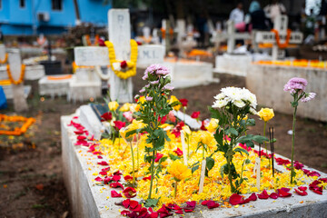 Christian community offer flowers and light candles for their departed family members on 