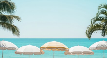 Tropical beach with umbrellas and palm trees on sunny day