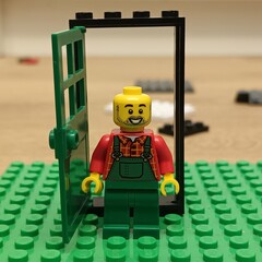 Naklejka premium A Lego farmer minifigure stands smiling cheerfully in a small green doorway on a vibrant green Lego baseplate, depicting a playful scene from the popular construction toy brand