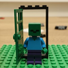 Naklejka premium Iconic Lego Minecraft Zombie Miniature Toy Standing In A Doorway
