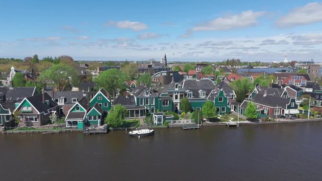 4K Aerial Drone Footage of Dutch Village Houses by the River in Zaanse Schans, Netherlands &ndash; Scenic Green Homes and Peaceful Water Landscape
