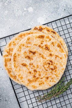 Homemade Kerala wheat paratha, layered parotta. grey background. top view