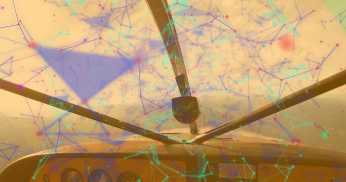 Framing windshield struts against hazy golden sky from cockpit, displaying network overlay graphics