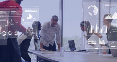 Collaborating team analyzing data around office conference table with laptop digital chart overlays