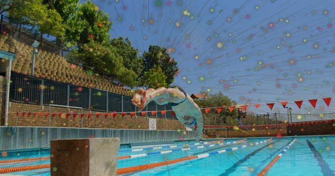 Diving male athlete wearing swim briefs plunging off block at outdoor pool with digital overlay