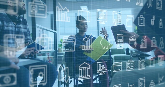 Diverse office team discussing financial data around wheelchair user in lounge, with green folder - Powered by Adobe