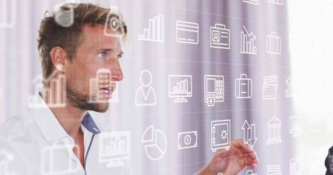 Presenting man interacting with floating data charts in office, finance icons, copy space